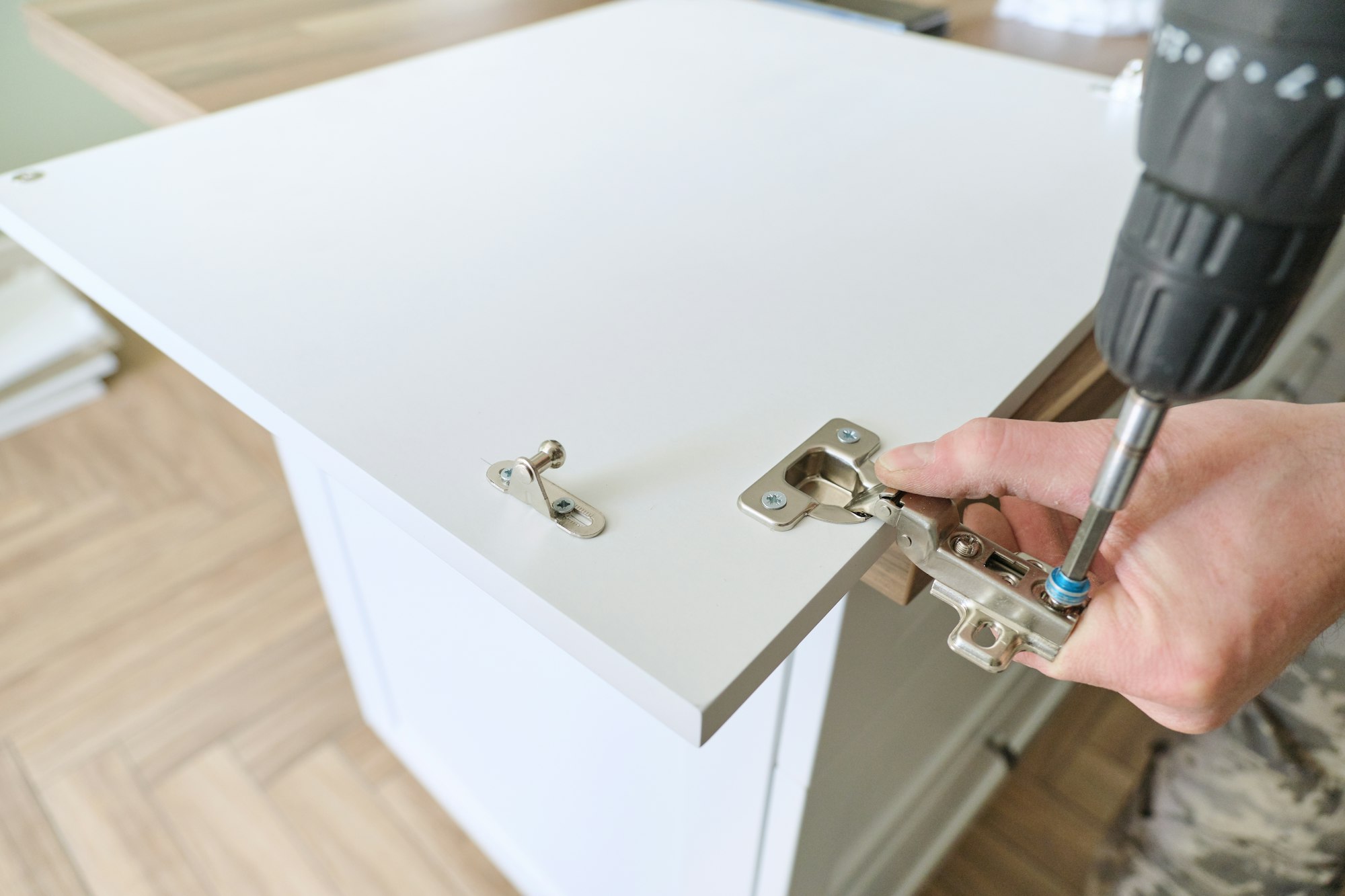 Closeup of furniture assembly with professional tools.